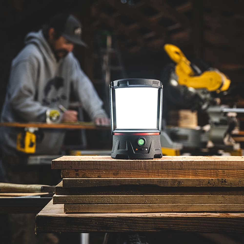 Coast EAL40R LED Lantern - Lantern on a stack of wood with a blurred workshop background