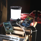 Coast EAL40R LED Lantern - Lantern with two smartphones charging on a wooden surface