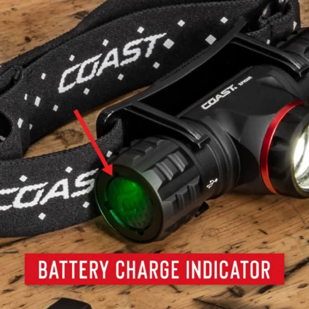 Coast XPH25R LED Torch - Coast headlamp with battery charge indicator on a wooden surface